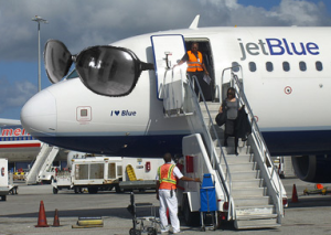 a jetblue plane with people boarding