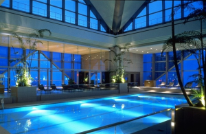 a indoor pool with a large glass wall