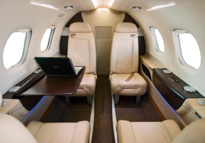 the inside of an airplane with a laptop