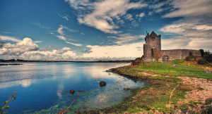 a castle on a hill next to a body of water