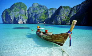 a boat in the water with Phi Phi Islands in the background