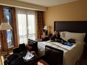 a woman lying on a bed in a hotel room