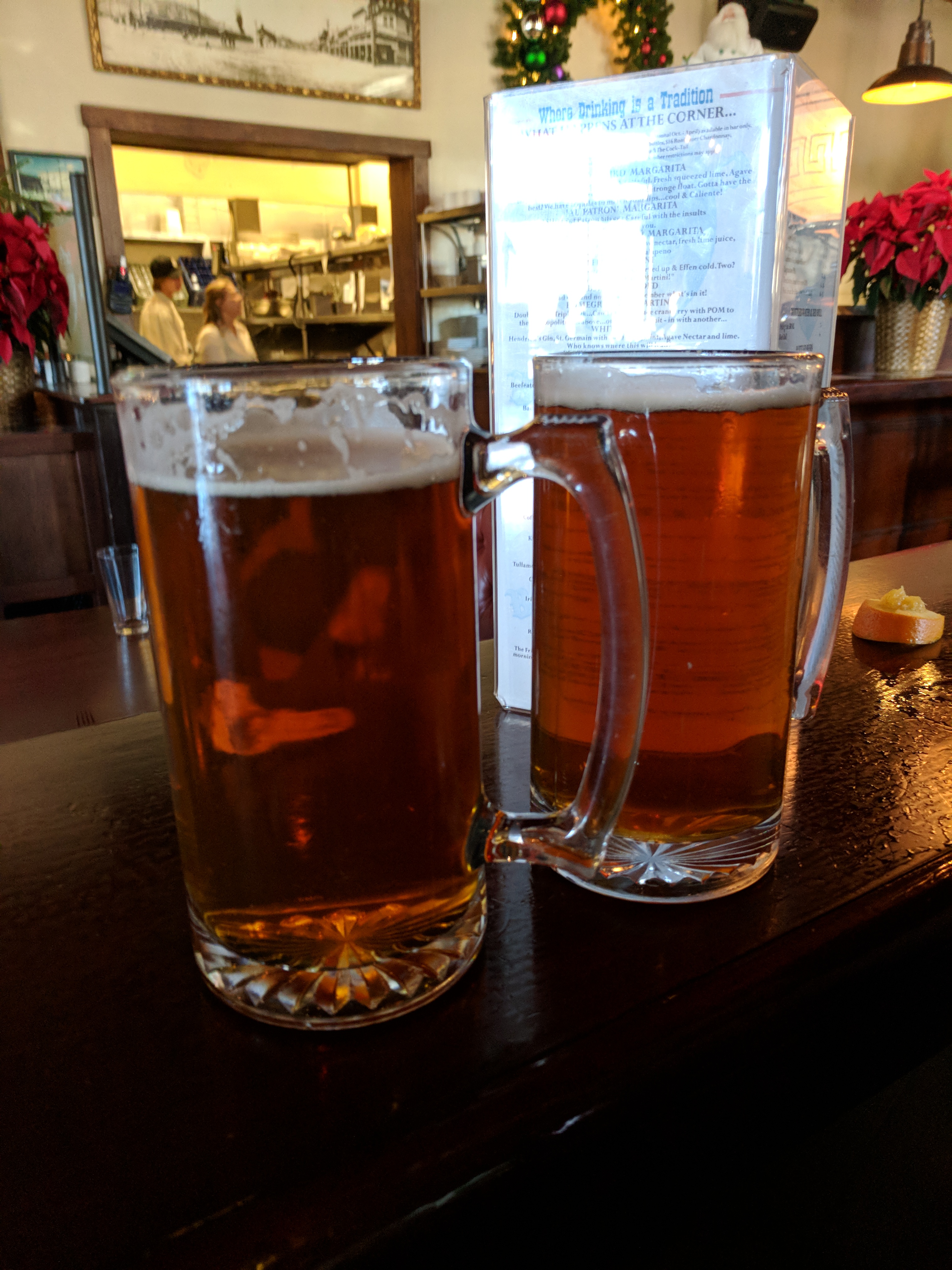 two glasses of beer on a bar